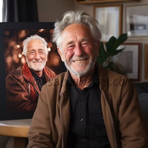 May include: A man with gray hair and a brown jacket smiles at the camera. Behind him is a framed photo of another man with a beard and a brown jacket.