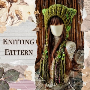 May include: A chunky knit olive green cat-ear hat featuring long braided tassels adorned with small green leaves and beads. The hat is displayed on a mannequin head with long brown hair. The text KNITTING PATTERN is visible on the left side.