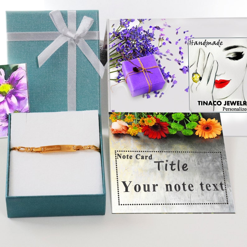 May include: A gold nameplate bracelet in a teal gift box with a white ribbon. The box is sitting on a white surface. A note card with the text "Note Card Title Your note text" is in the background.