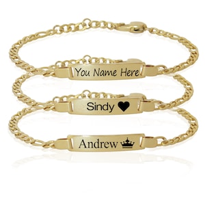 May include: Three gold chain bracelets with personalized nameplates. The top bracelet has the text "You Name Here", the middle bracelet has the name "Sindy" with a heart symbol, and the bottom bracelet has the name "Andrew" with a crown symbol.