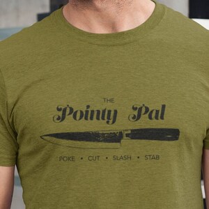 May include: A green t-shirt with a black graphic of a knife and the text "The Pointy Pal" with the words "poke, cut, slash, stab" underneath.