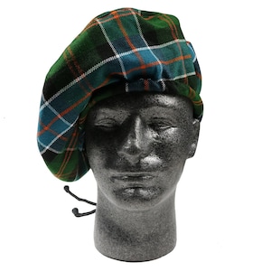 May include: A green, blue, and orange plaid beret with a black drawstring.