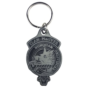May include: Silver-toned keychain featuring a clan crest with the text "Clan MacIver Nunquam Obliviscar".