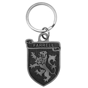 May include: Silver keychain with a shield-shaped charm featuring a black lion and the name "FARRELL" in a scroll above it.