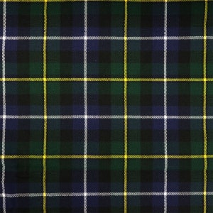 Pode incluir: Um tecido xadrez verde, azul e amarelo com um padrão repetitivo.