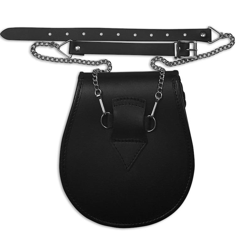 May include: Black leather sporran with a chain strap and a buckle. The sporran has a triangular flap on the front and two metal rings on the sides.