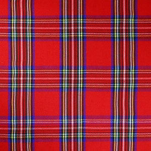 May include: Close-up of a red plaid fabric with a repeating pattern. The plaid design features vertical and horizontal stripes in white, blue, yellow, and black, creating a classic tartan pattern. The fabric has a woven texture.