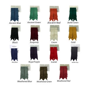 May include: A set of 14 kilt hose flashes in various colors, including ancient blue, ancient green, ancient red, bottle green, black, burgundy, cream, gold, navy blue, royal purple, scarlet, stealth grey, weathered blue, and weathered green. Each flash is packaged on a card with the brand name "Lochcarron" printed on it.