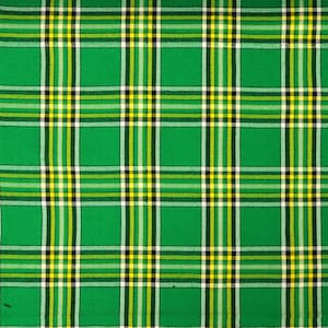 May include: Green, white, and yellow plaid fabric with a woven texture.