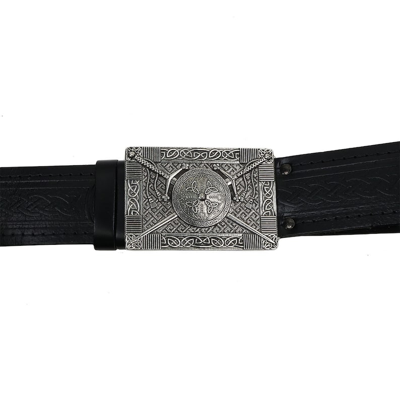 May include: A black leather belt with a silver buckle featuring a Celtic knot design with a shield and crossed swords.