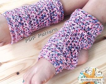 May include: A pair of pink, white, and blue crocheted leg warmers. The leg warmers are folded over at the top and are worn on a person's legs. The text "PDF Pattern" is written in white on a black background. The image also includes a small image of a starfish with the text "Sea Star Crochet".