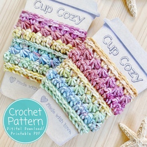 May include: A crochet pattern for a colorful cup cozy. The pattern is available as a digital download and includes instructions for making a cozy with a multi-colored striped design. The text on the image reads "Cup Cozy" and "Made with love."