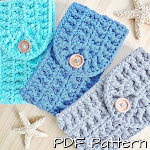 May include: Three crocheted phone cases in blue, teal and grey with a button closure. The cases are made with a textured stitch and have a simple, modern design.  PDF Pattern.