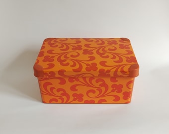 Orange vintage plastic box from the 60s, floral pattern
