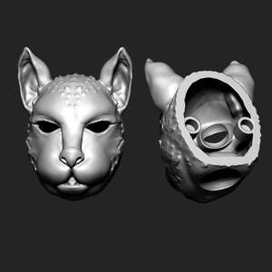 May include: A 3D printed model of a cat's head, shown from the front and the back. The back view shows the hollow interior of the model.