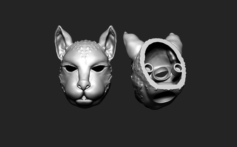 May include: A 3D printed model of a cat's head, shown from the front and the back. The back view shows the hollow interior of the model.