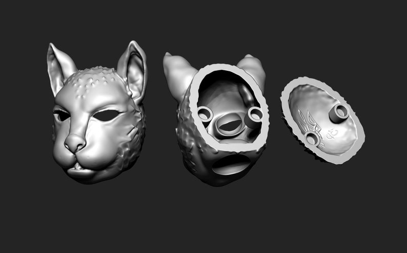 May include: A 3D printed model of a cat's head, shown in three views: front, back, and inside. The model is hollow and has a smooth, detailed surface.