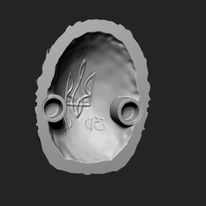 May include: A grey, oval-shaped mould with a raised design of the Ukrainian trident symbol and the letters "ФЕ" in the centre. The mould has two circular holes on the sides.