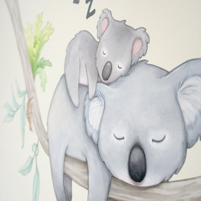 May include: A watercolor illustration of two koalas sleeping on a branch. The larger koala is lying on its back with its arms outstretched, while the smaller koala is curled up on its chest. Both koalas have closed eyes and are depicted in shades of gray.