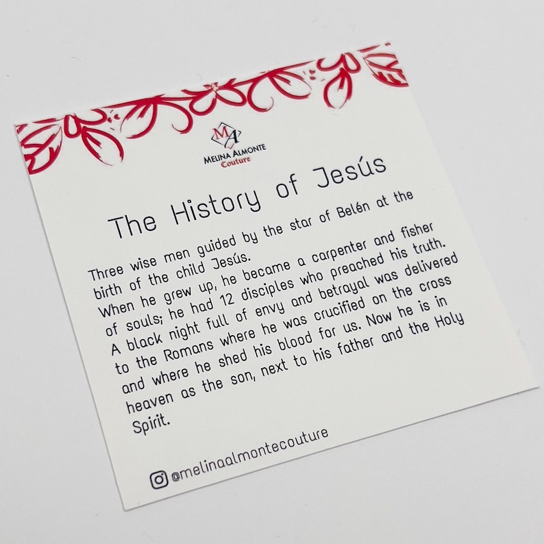 May include: A white card with black text describing the history of Jesus. The card has a red floral border and the text "The History of Jes&uacute;s" at the top. The text includes the words "Three wise men", "carpenter", "fisher", "disciples", "betrayal", "crucified", "heaven", "Holy Spirit", and "@melinaalmontecouture".