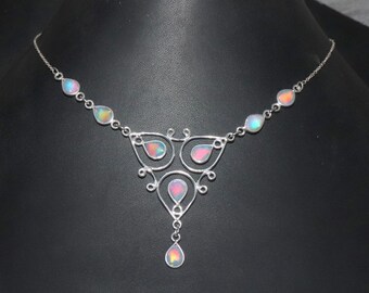 May include: A silver necklace with a delicate, intricate design features iridescent teardrop-shaped stones. The necklace has a pendant with a larger teardrop stone.