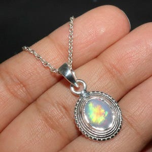 Natural Ethiopian Opal Pendant: Sterling Silver Oval Cabochon (7x9mm)