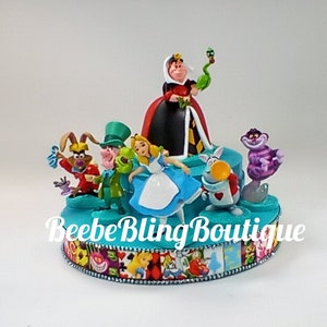 Disney Alice in Wonderland cake topper.  The Queen of Hearts and Alice centerpiece decoration. A great keepsake for your memories.