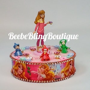Disney Princess Aurora and the 3 good fairies cake topper.  Sleeping Beauty and her guardian fairies centerpiece.  Great keepsake.