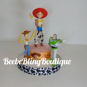 Disney Toy Story cake topper, Jessie and Woody, and Buzz Lightyear centerpiece.