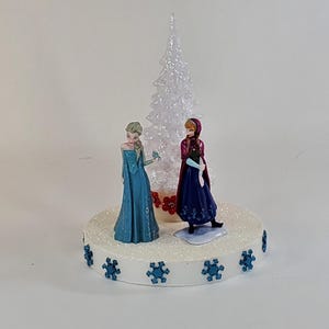 Disney Frozen cake topper, Christmas decoration with Queen Elsa and Princess Anna centerpiece.
