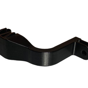 May include: Black 3D printed GoPro mount with a curved handle and a standard GoPro mount on the end.