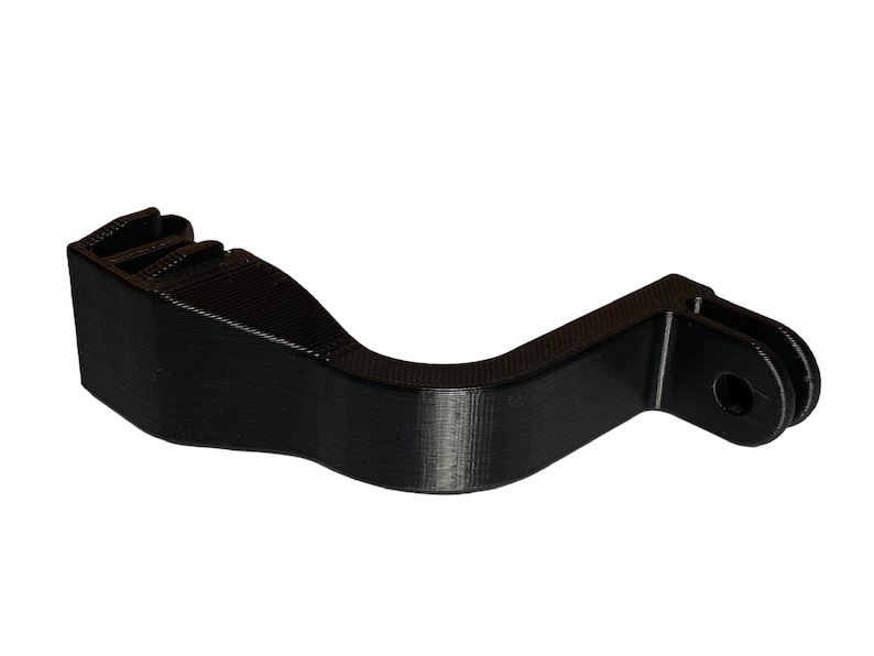 May include: Black 3D printed GoPro mount with a curved handle and a standard GoPro mount on the end.