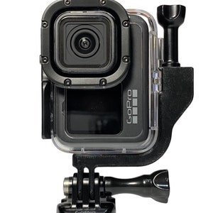 May include: A black GoPro camera with a clear waterproof case and a black GoPro mount. The camera is facing forward and the mount is attached to the bottom of the case.