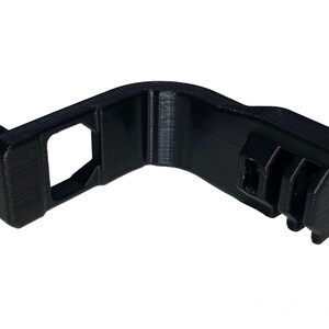 May include: Black plastic 3D printed adapter with a GoPro mount on one end and a square opening on the other end.
