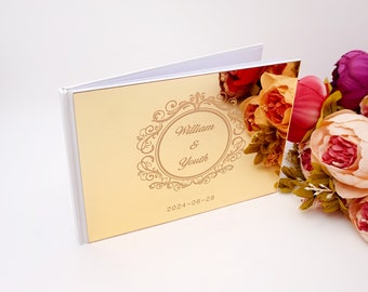 May include: Gold mirror guest book with a white cover and a decorative frame with the text "William & Youth" and the date "2024-06-29".
