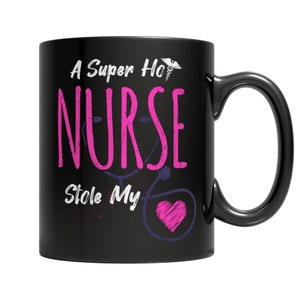 May include: Black coffee mug with a white graphic that says "A Super Hot Nurse Stole My Heart" with a pink heart and a stethoscope.