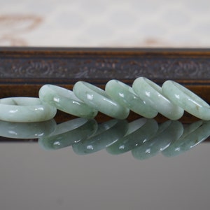 Genuine jade ring in width of 5.7mm and more in jadeite type that categorized in three ranges of color shades for woman and man