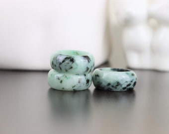 Genuine Wide Jade ring in jadeite type in green base color with scattered of dark green spots for any gender such as woman and man.