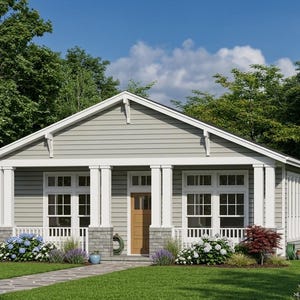 May include: A light gray house with white trim, a brown door, and a porch with white columns. The house has multiple windows and is surrounded by green grass, trees, and colorful flowers.