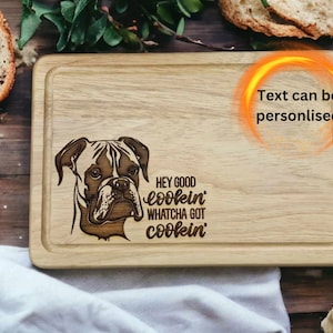 30cm x 20cm hevea wood chopping board featuring a lasered on design of a boxer dog scottish terrier dog with the wording Hey Good lookin, whatcha got cookin?