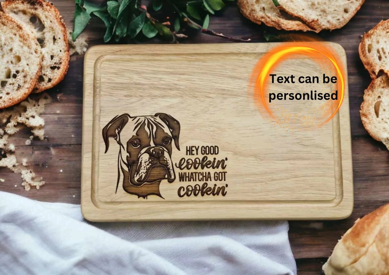 30cm x 20cm hevea wood chopping board featuring a lasered on design of a boxer dog scottish terrier dog with the wording Hey Good lookin, whatcha got cookin?