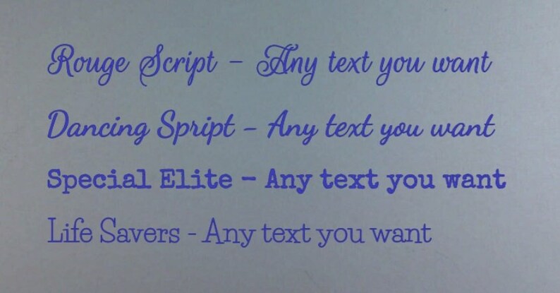 May include: A close-up of a white surface with four lines of text in blue. The text reads: "Rouge Script - Any text you want", "Dancing Spript - Any text you want", "Special Elite - Any text you want", and "Life Savers - Any text you want".