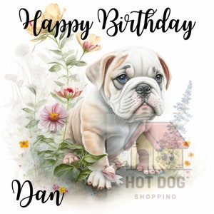 May include: Happy Birthday Dan! A white and tan bulldog puppy sits in a field of flowers. The puppy is looking at the camera with a sweet expression.