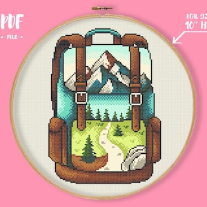 May include: Cross-stitch design of a backpack with a mountain scene. The backpack is teal and brown with leather straps and buckles. The scene inside the backpack features mountains, trees, and a winding path. The text "PDF FILE" is in the upper left corner. The text "REAL SIZE IN 10" HOOP" is in the upper right corner.