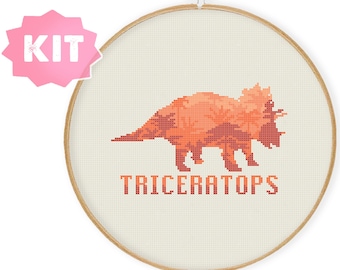 May include: Cross stitch kit featuring a red and orange triceratops with the text "TRICERATOPS" below.