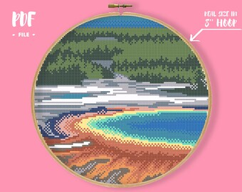 May include: Cross stitch pattern of a colourful landscape with a blue lake, green trees, and a white sky. The pattern is designed to fit in an 8-inch hoop. PDF file.