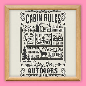 May include: Black and white cabin rules sign with a rustic design. The sign features text that reads "Cabin Rules" and includes phrases like "Take a long nap", "Read a book", "Sit around the campfire", "Just be yourself", "Become one with nature", and "Enjoy the outdoors".