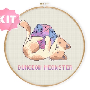 May include: A cross-stitch kit featuring a cartoon cat holding a large, multi-colored dice with the text "Dungeon Meowster".