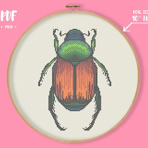 May include: A cross-stitch pattern of a beetle in a 10-inch hoop. The beetle is rendered in pixelated style, with a green head, orange and brown body, and black legs. The text "PDF FILE" is in the upper left corner.