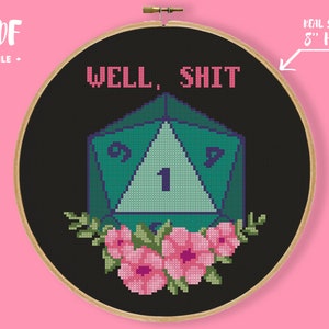 May include: Cross-stitch design in an 8-inch hoop with the text "WELL, SHIT" above a teal and purple D20 die, surrounded by pink flowers and green leaves. The words "PDF FILE" are in the upper left corner.